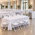 White banquet tables and folding chairs arranged for event rentals
